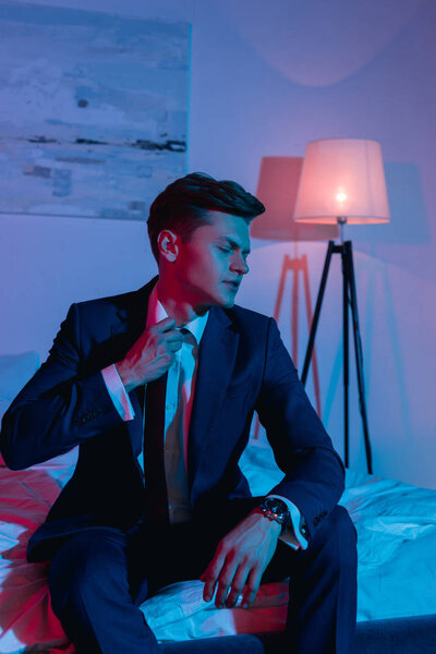 businessman taking off necktie