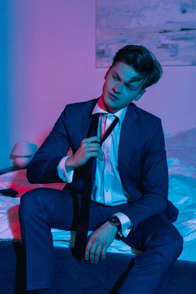 businessman taking off necktie