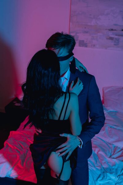 woman embracing her blindfolded boyfriend