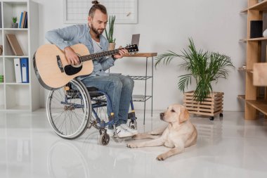 adam gitar çalmak tekerlekli sandalye üzerinde