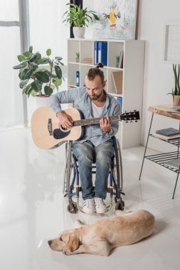 adam gitar çalmak tekerlekli sandalye üzerinde