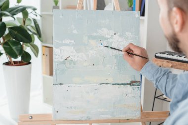 man painting on canvas clipart