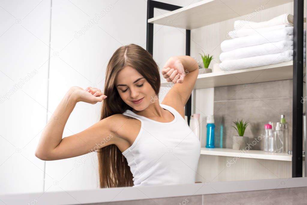 girl stretching in bathroom