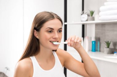 Girl brushing teeth clipart