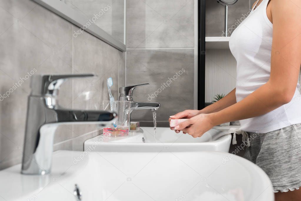 woman washing hands with soap