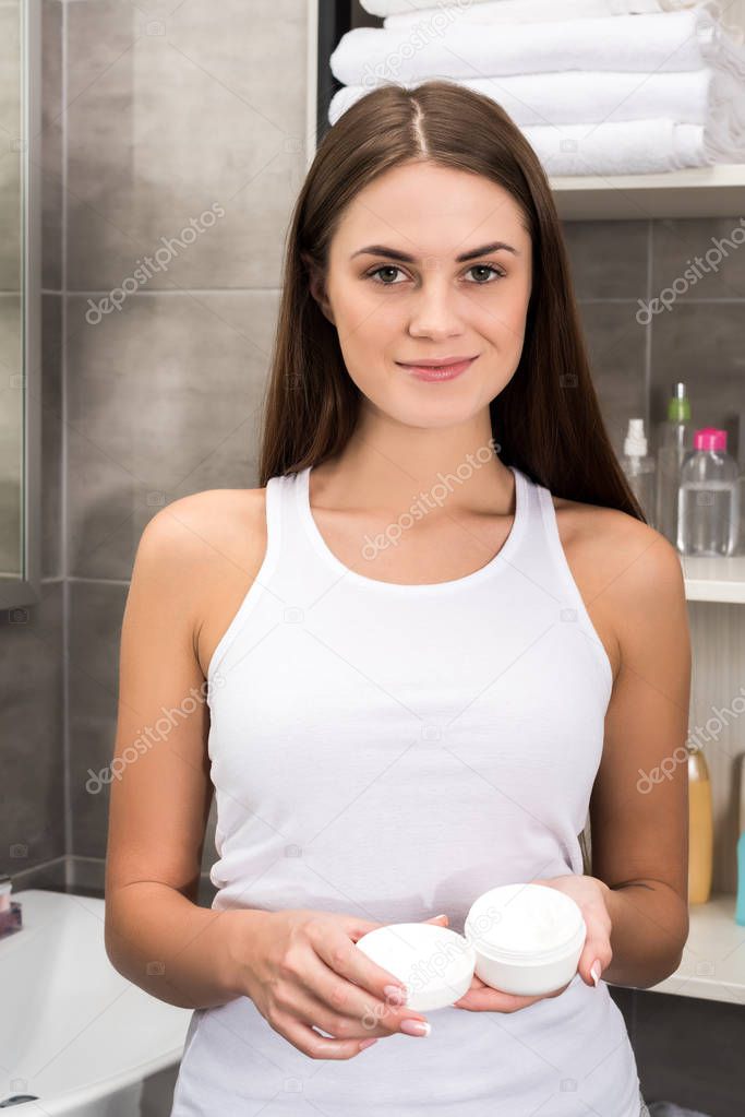 woman standing with open cream