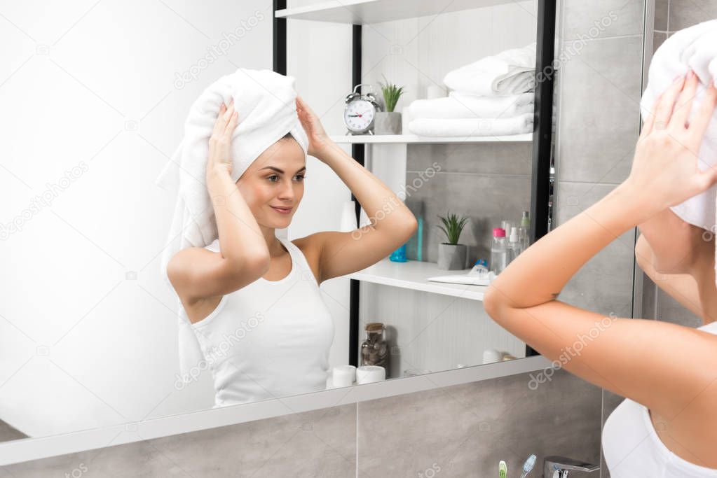 Woman putting towel on head