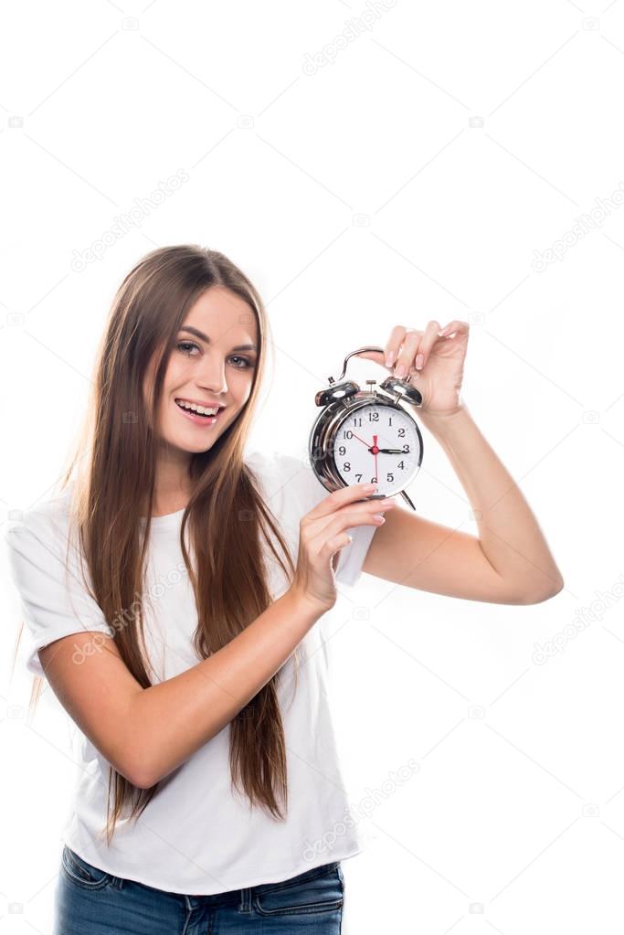 Girl holding alarm clock