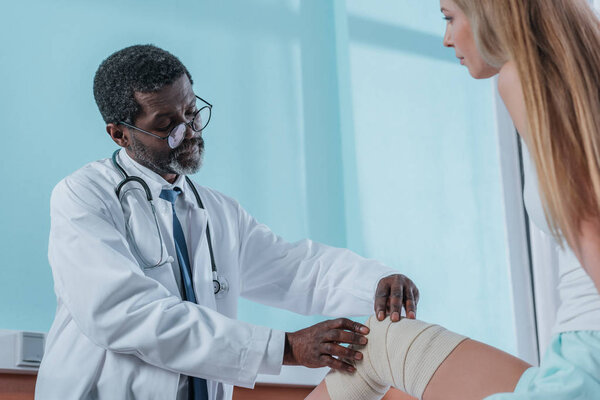 doctor putting on elastic bandage