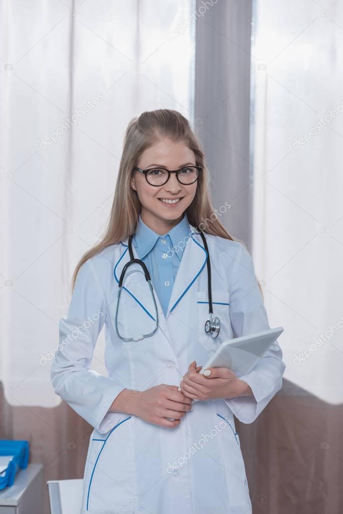 doctor standing with tablet 