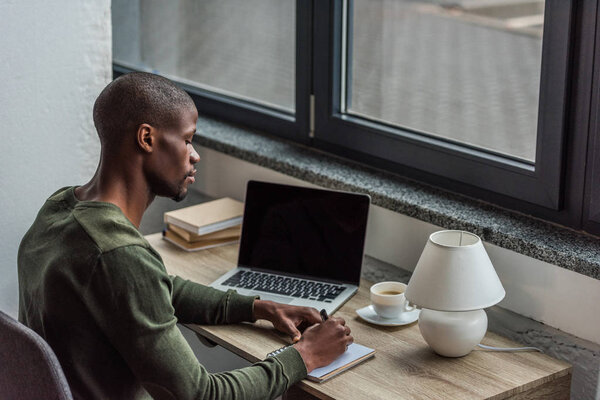 african american man making notes