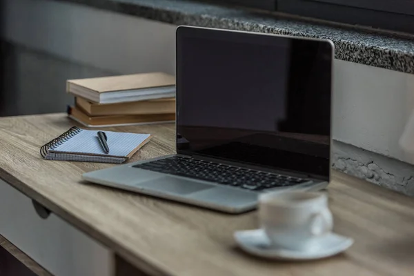 Laptop and notebook on table — Stock Photo, Image