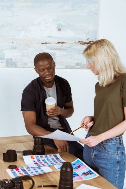 çok kültürlü fotoğrafçılar portföy birlikte işyerinde ofiste tartışıyor