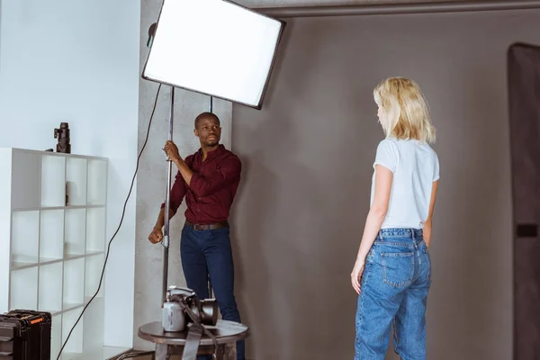 African American Photographer Correcting Light Photoshoot Studio — Stock Photo, Image