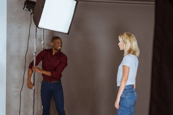 African American Photographer Correcting Light Photoshoot Studio — Free Stock Photo