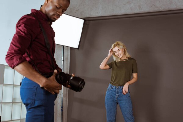 multiethnic photographer and model having photoshoot in studio