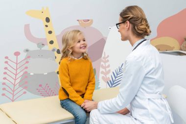 female doctor with little girl clipart