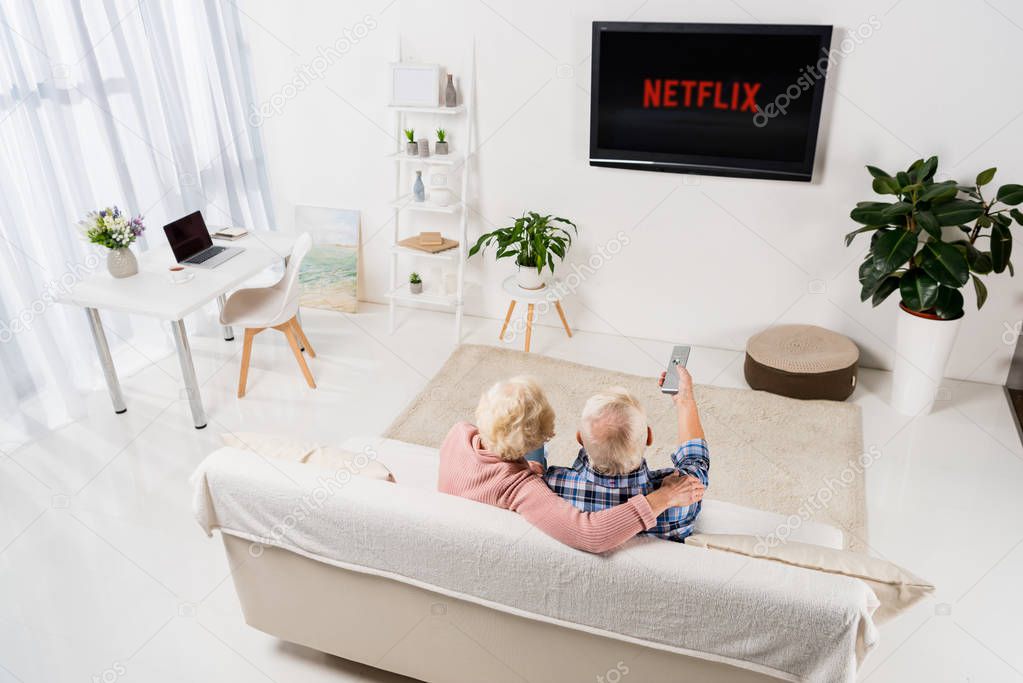 Senior couple watching netflix on tv at home