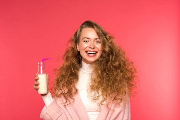 happy woman holding milkshake isolated on red