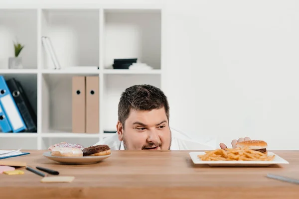 Hungry Fat Businessman Choosing Donuts Hamburger French Fries Lunch — Stock Photo, Image