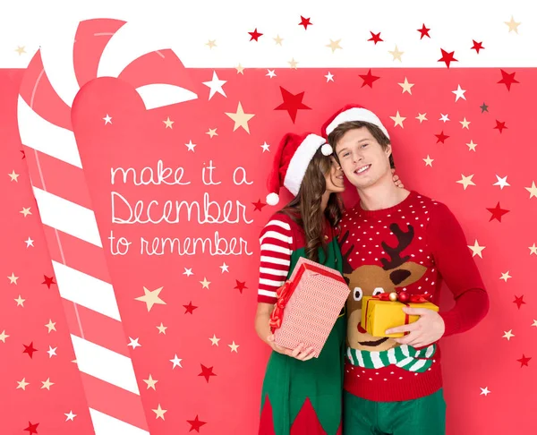 Paar in Weihnachtsmützen mit Geschenken — Stockfoto