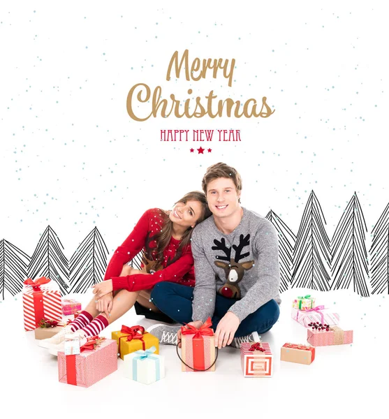Couple in winter sweaters with gifts — Stock Photo, Image