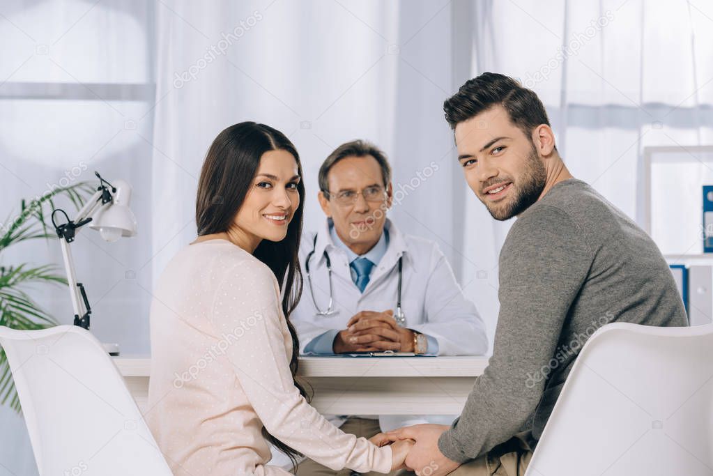 happy couple holding hands at clinic