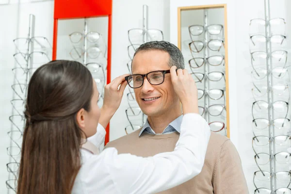 Oculist Helping Man Choose Pair Eyeglasses Optics — Stock Photo, Image