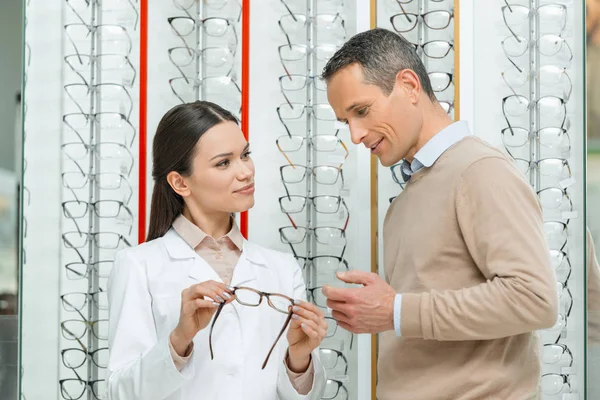 Oculist Helping Man Choose Pair Eyeglasses Optics — Stock Photo, Image