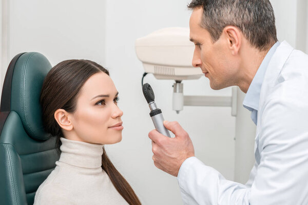 side view of patient getting eye test by oculist in clinic