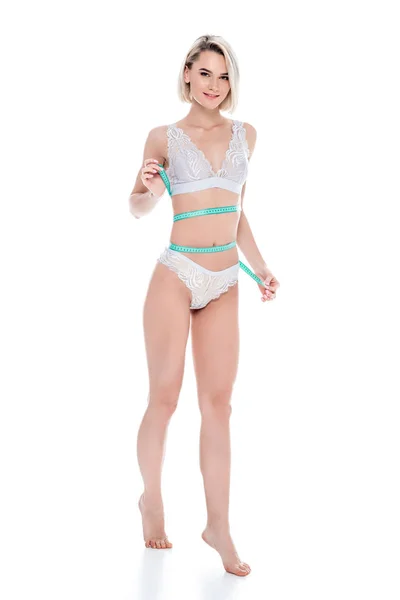 Menina Sorridente Lingerie Medindo Seu Corpo Magro Perfeito Isolado Branco — Fotografia de Stock