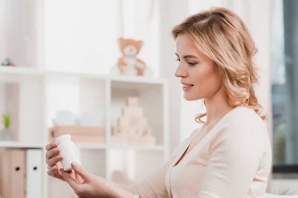 Side View Smiling Woman Looking Pills Hands — Stock Photo, Image