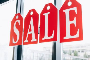 sale sign made of tags with letters on windows of boutique clipart