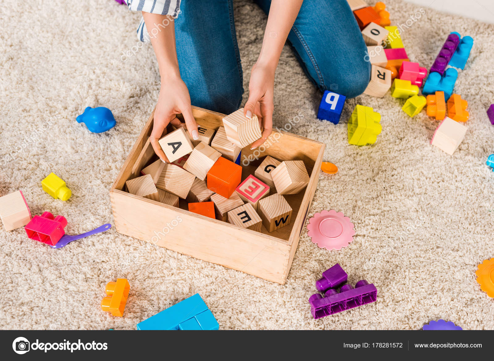 Cropped Image Woman Collecting Children Toys Stock Photo by