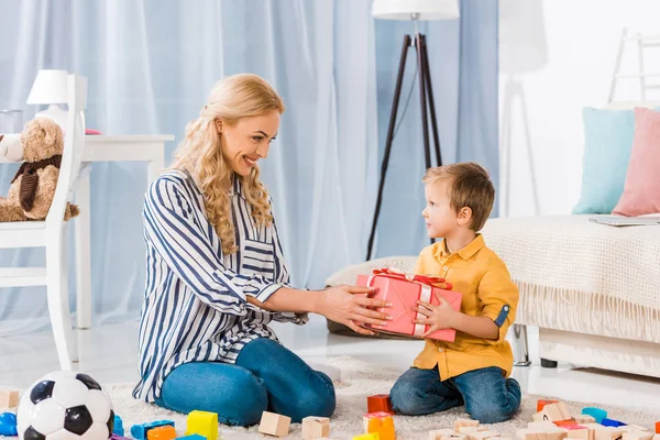 Smiling Mother Presenting Gift Little Son Home — Free Stock Photo