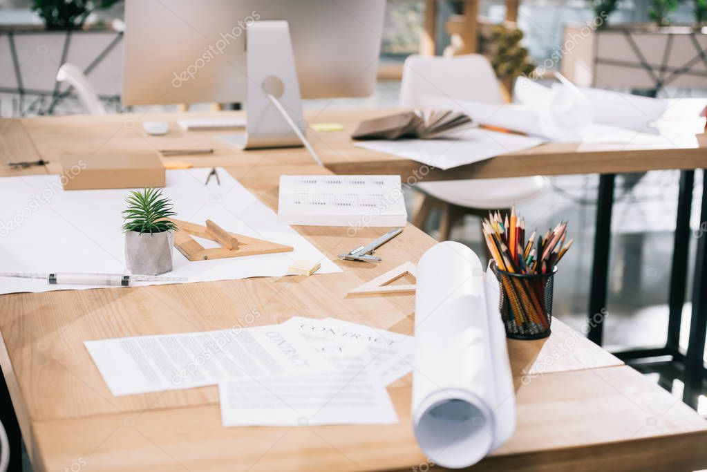 blueprints and documents on table in modern architect office 