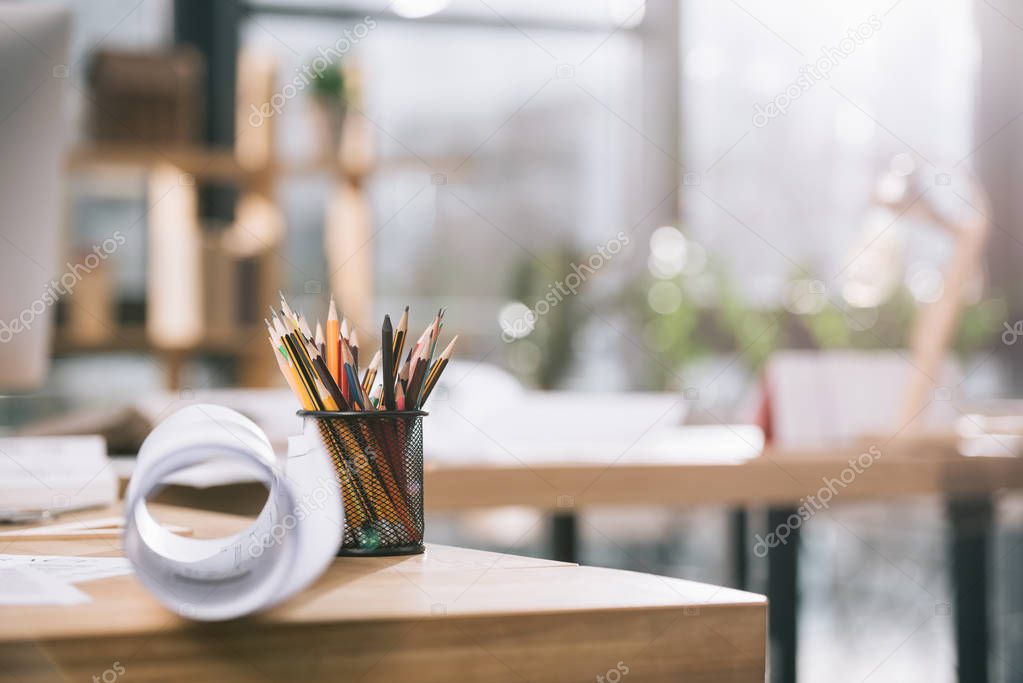 blueprint and pencils on table in modern architect office