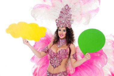 woman in carnival costume holding yellow empty text balloon and another one green, isolated on white    clipart