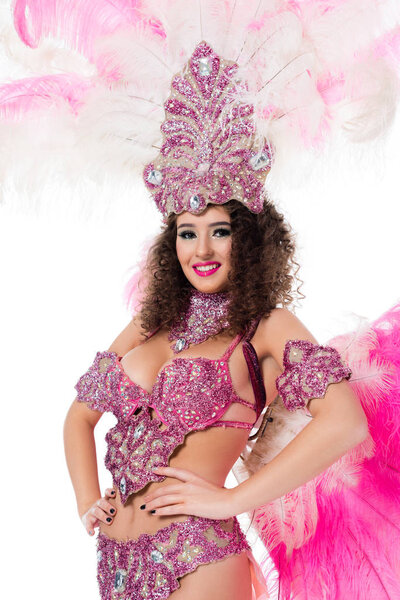 cheerful girl in carnival costume with pink feathers and gems, isolated on white