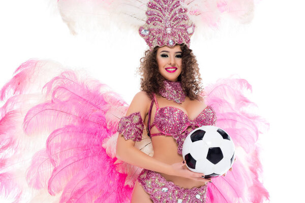 woman in carnival costume holding football ball in hands, isolated on white 