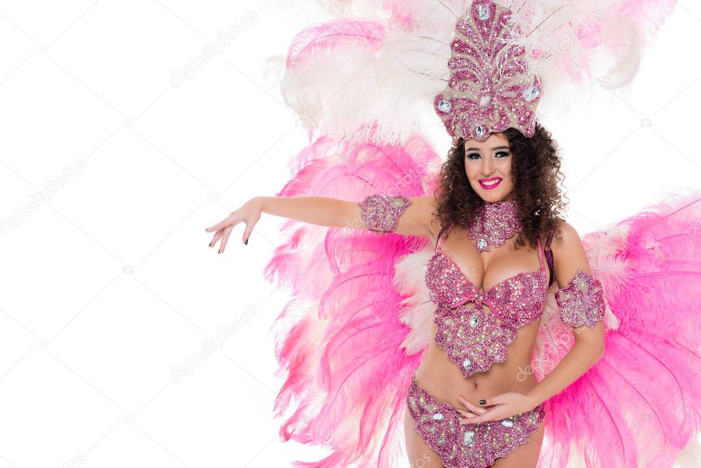 smiling girl posing in carnival costume with pink feathers, isolated on white