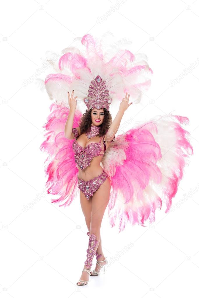 beautiful girl posing in carnival costume with pink feathers, isolated on white