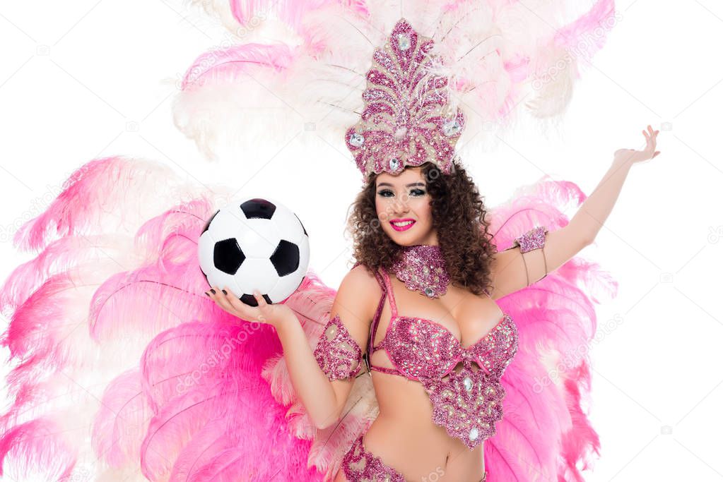 woman in carnival costume holding football ball in hand and looking at camera, isolated on white  