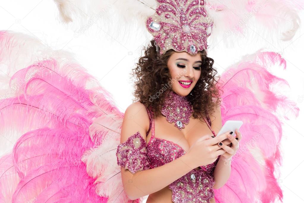 woman in carnival costume using smartphone, isolated on white