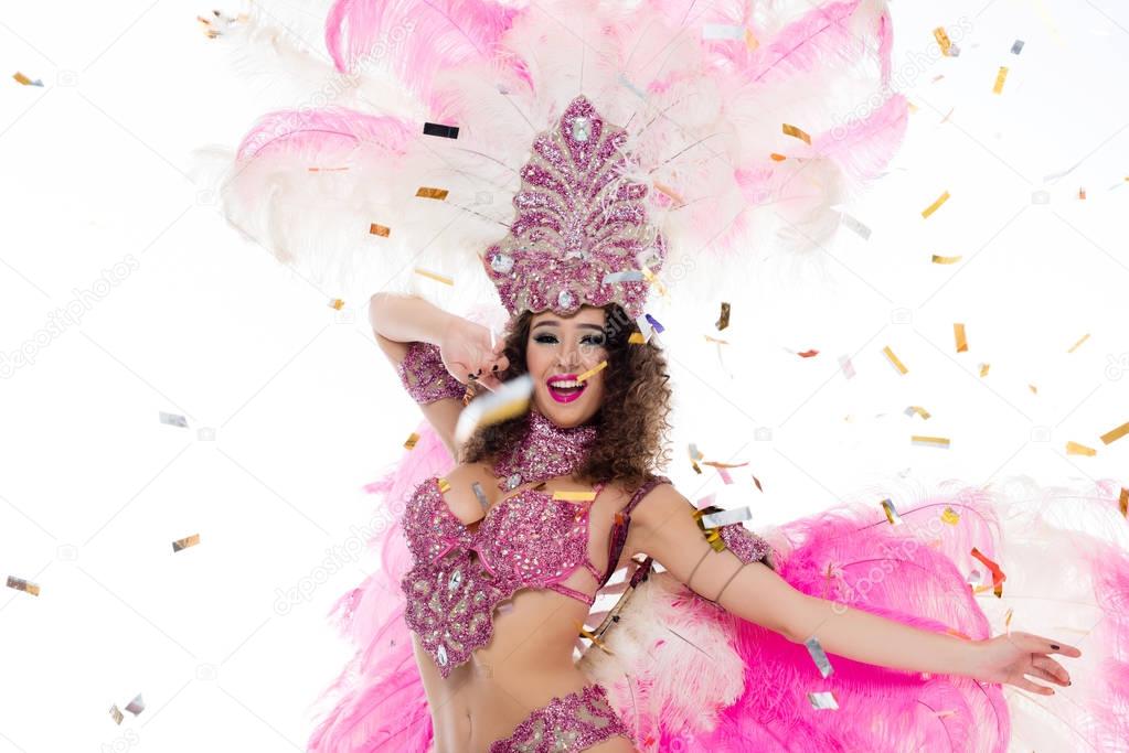 young woman in carnival costume surrounded by confetti, isolated on white
