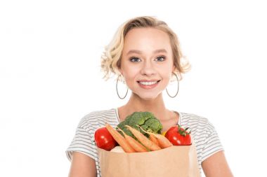 bakkal çantası tutarak ve üzerinde beyaz izole kamera bakıyor güzel genç kadın 