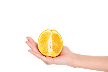 close-up partial view of woman holding half of fresh ripe orange isolated on white clipart
