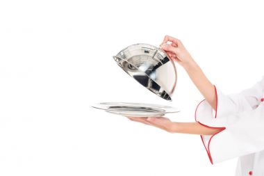 cropped shot of chef holding empty serving tray with dome in hands isolated on white clipart