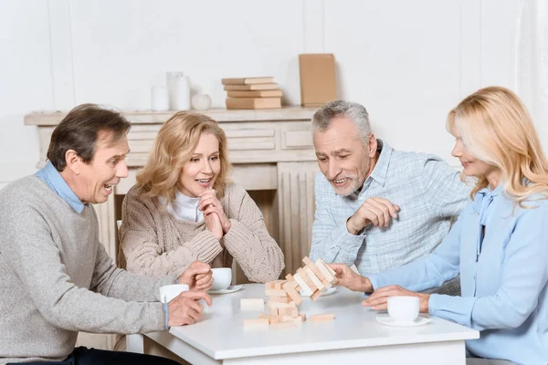 Happy Friends Sitting Table Tea Playing Tower Game — Stock Photo, Image