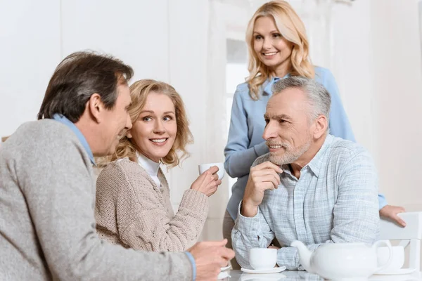 Happy Friends Drinking Tea While Sitting Table — Stock Photo, Image